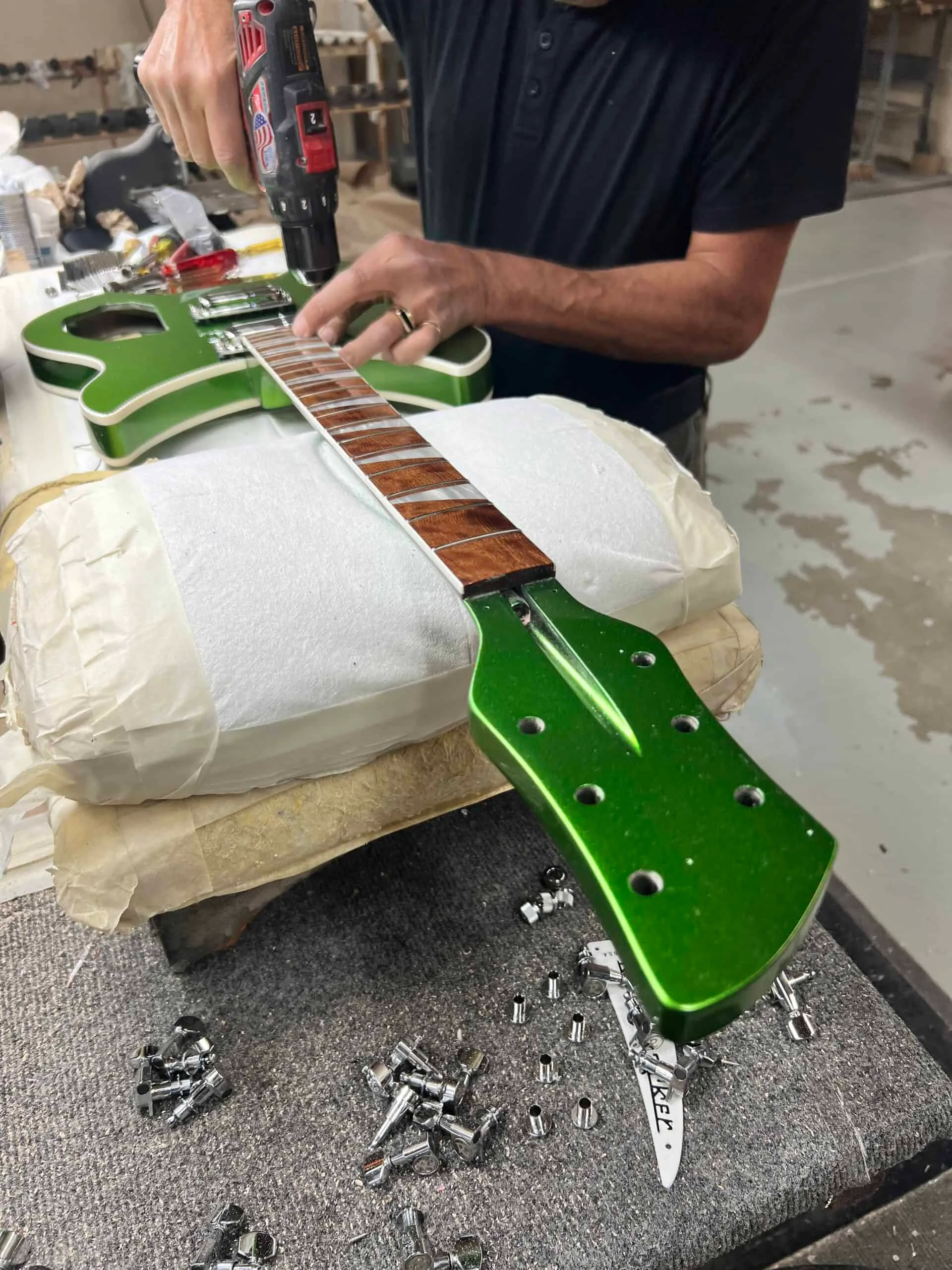 Guitar hardware placed on body during assembly
